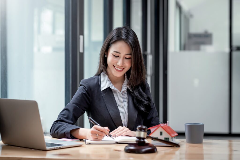 Woman working at desk with laptop and legal stuff
