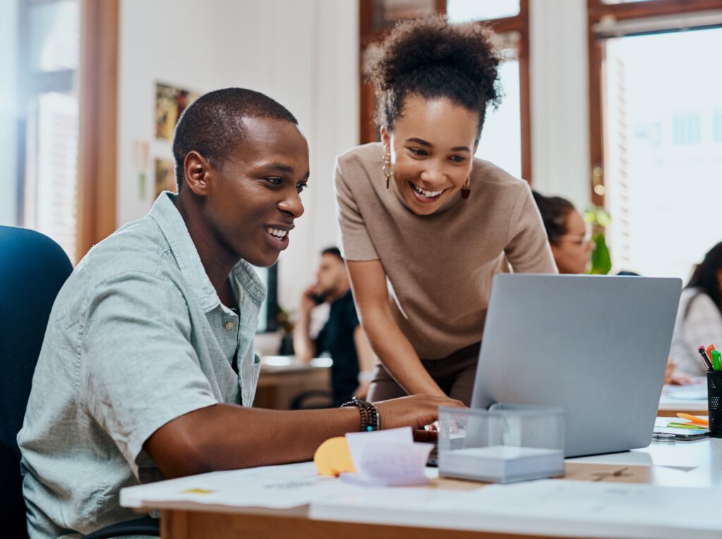 Two people looking at a laptop